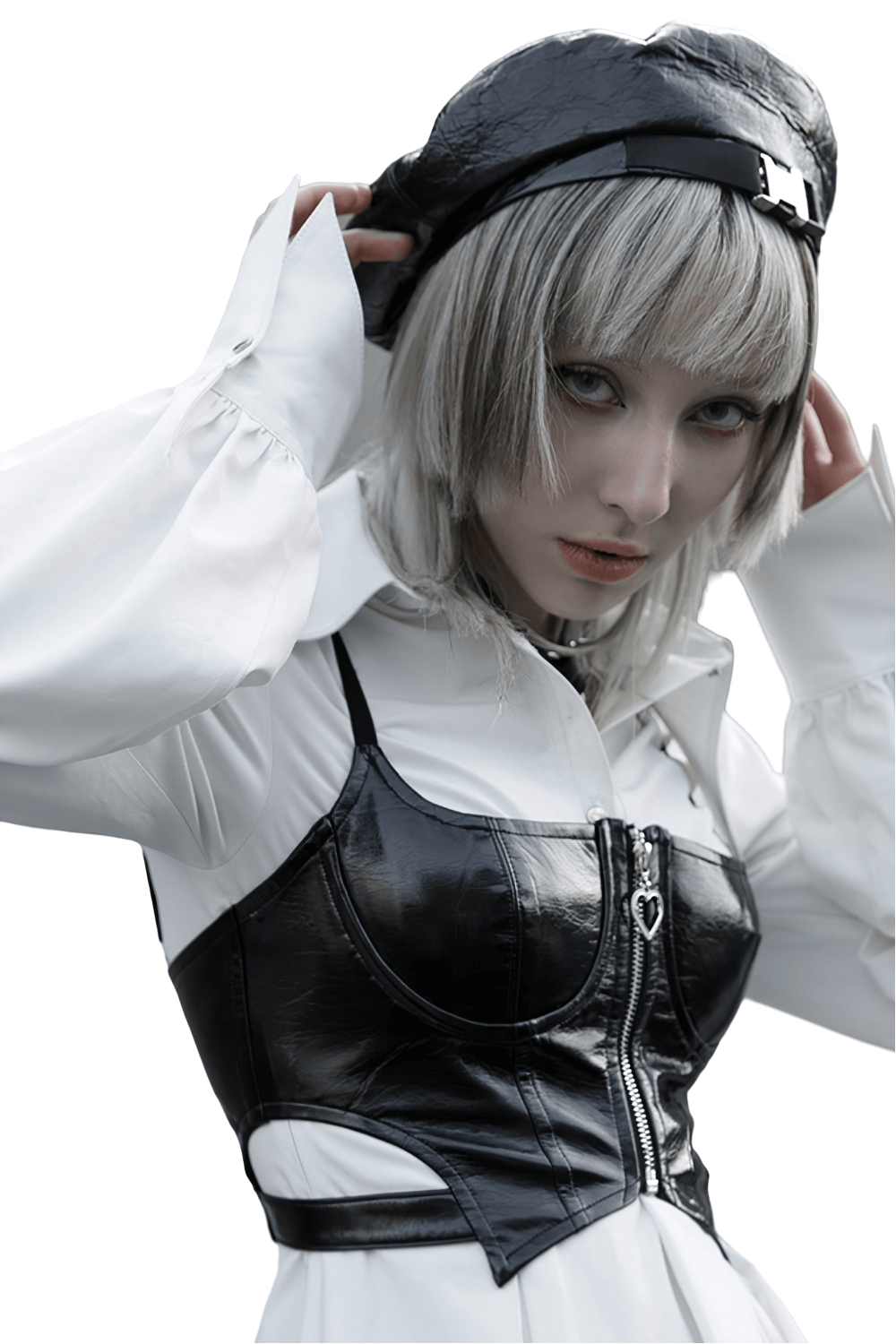 Model wearing a sexy punk rave black PU leather zipper crop camisole, styled with a fashionable white blouse and hat.
