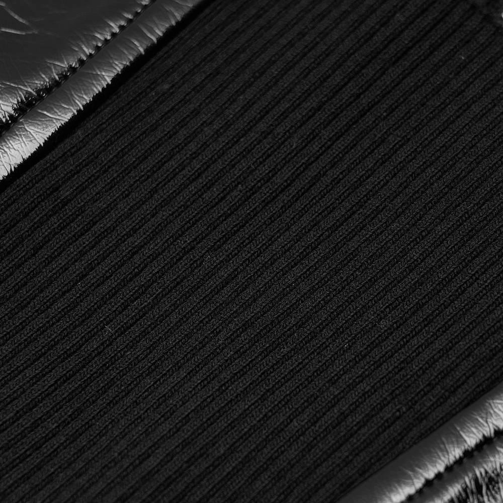 Close-up of black ribbed fabric bordered by PU leather, showcasing edgy texture for a stylish punk look.