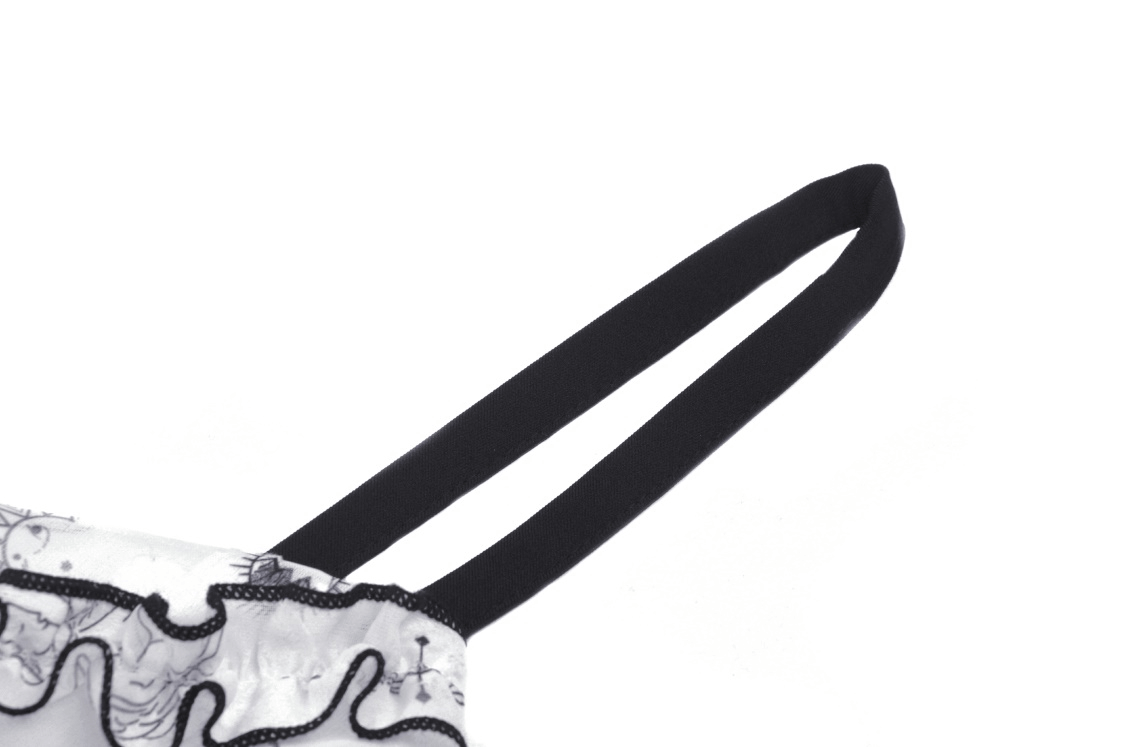 Close-up of strappy details on a sexy punk dress with black lace trim and playful animal print.