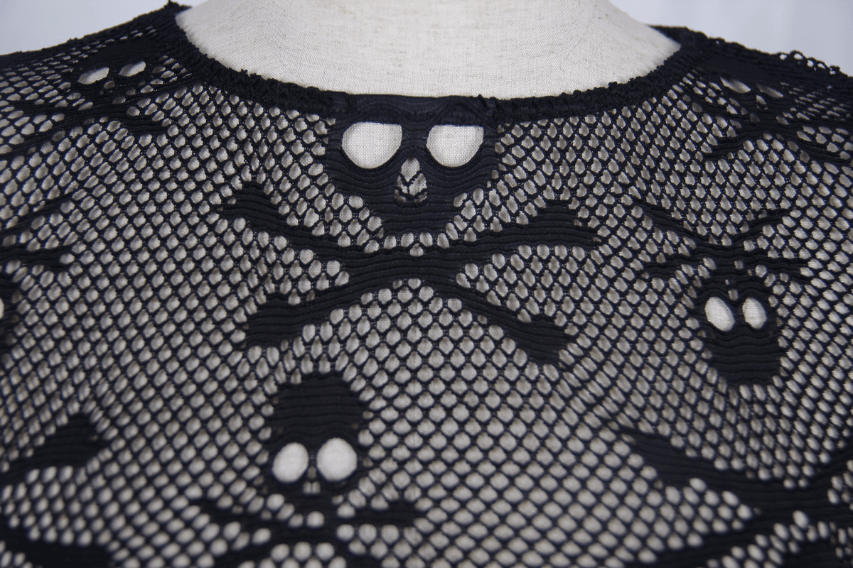 Close-up of black mesh skull top featuring skull and crossbones pattern, perfect for gothic fashion lovers.
