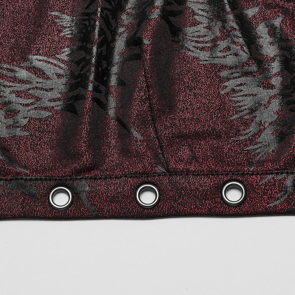 Close-up of red and black dragon print fabric featuring large iron rings for edgy detail.