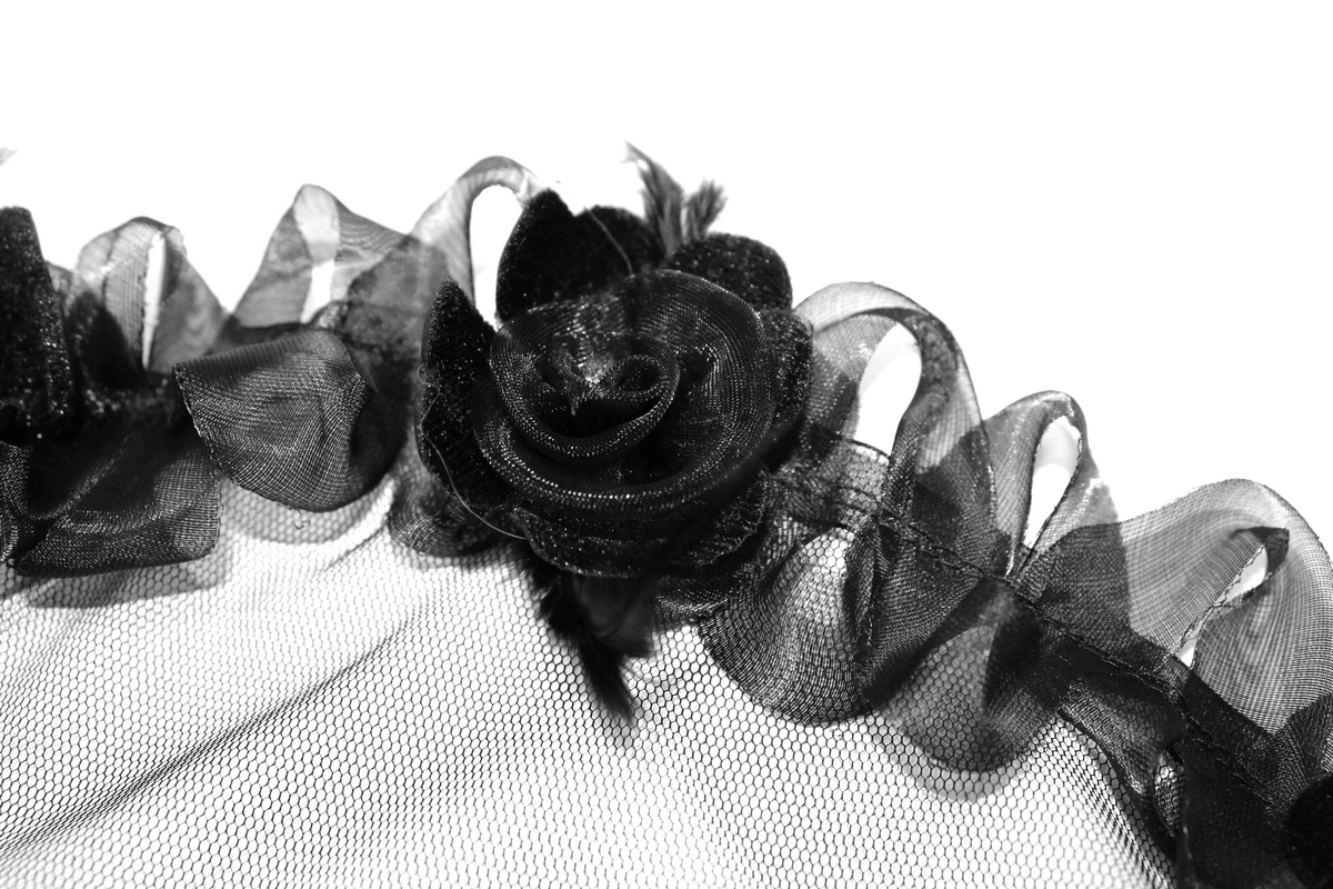 Close-up of black lace fabric with rose detail, perfect for gothic or sexy lingerie designs.