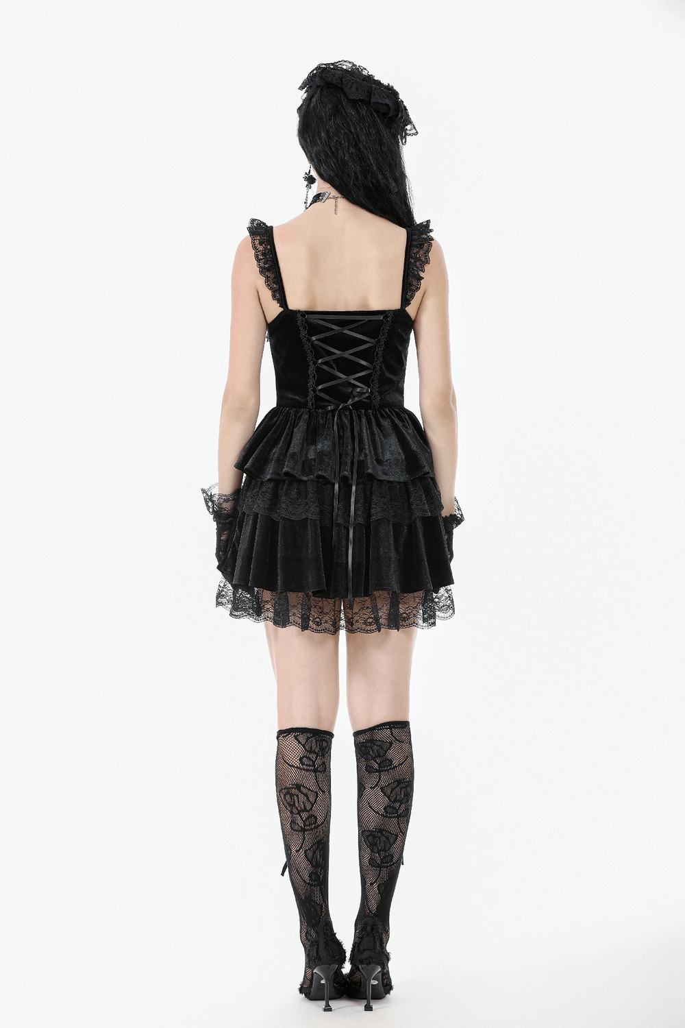 Back view of a sexy black velvet lace tiered mini dress with corset and ruffles, showing intricate detailing.