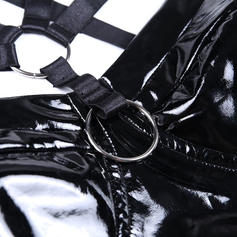 Close-up of black leather tank top featuring stylish straps and ring details, perfect for gothic fashion.