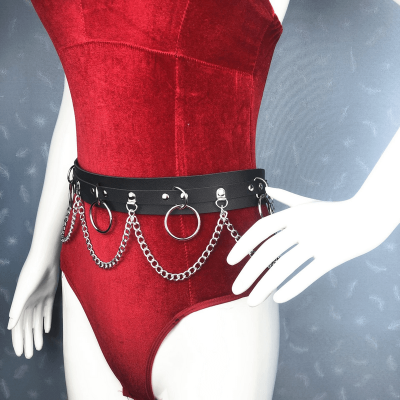 Sexy women's belt with rings and chains on red bodysuit, showcasing edgy alternative fashion accessory.
