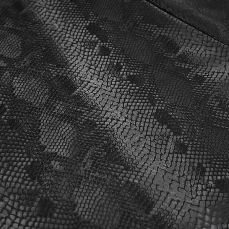 Close-up of textured black synthetic leather with a snake skin pattern, perfect for gothic fashion skirts.