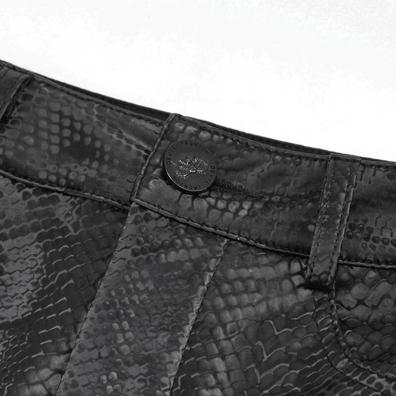 Close-up of a black synthetic leather skirt with a trendy snake print pattern and button detail, perfect for gothic fashion.