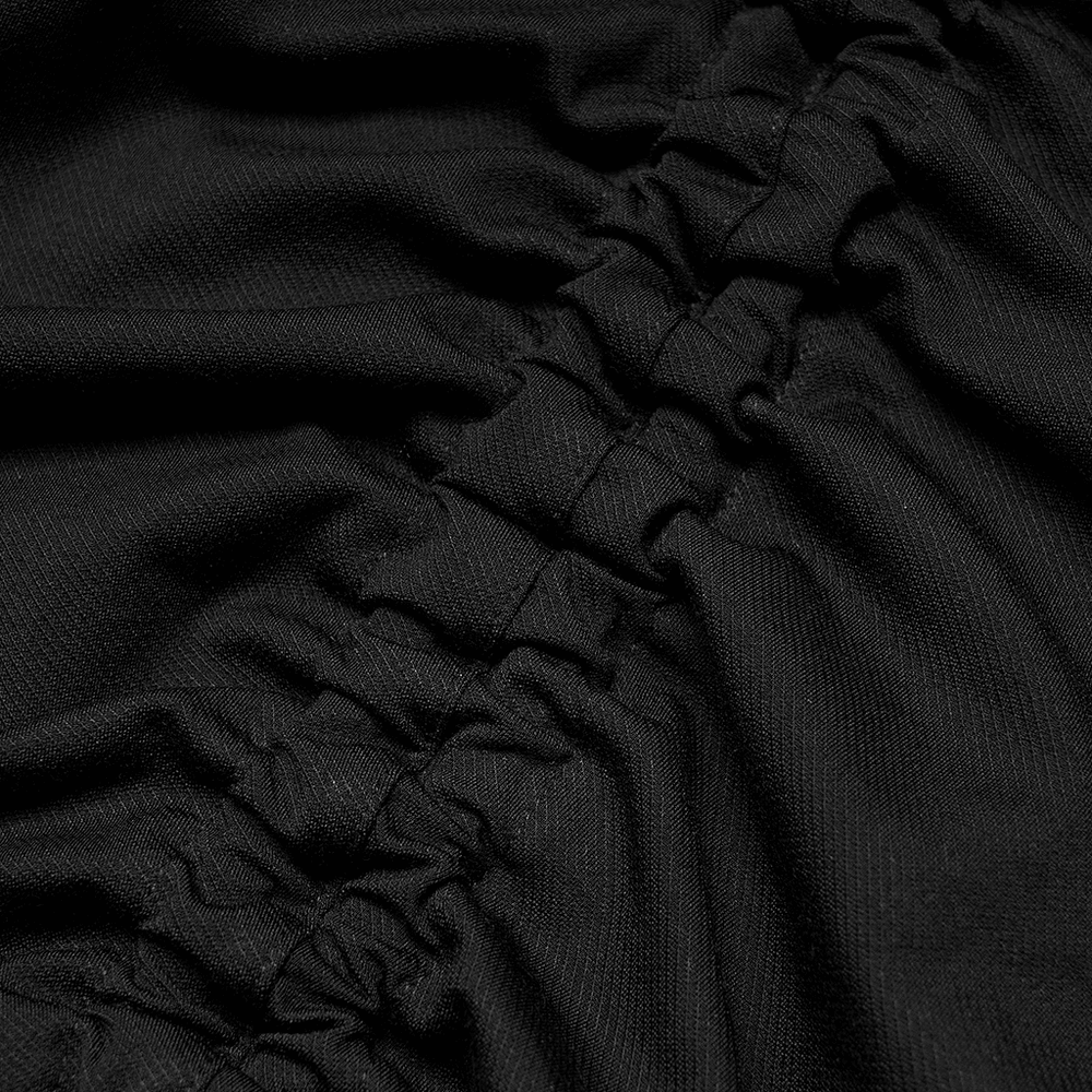 Close-up of black drawstring fabric showcasing elegant folds and adjustable details for a bodycon mini dress.