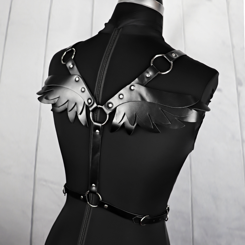 Gothic black harness with angel wing design on mannequin, perfect for cosplay or rock festivals.