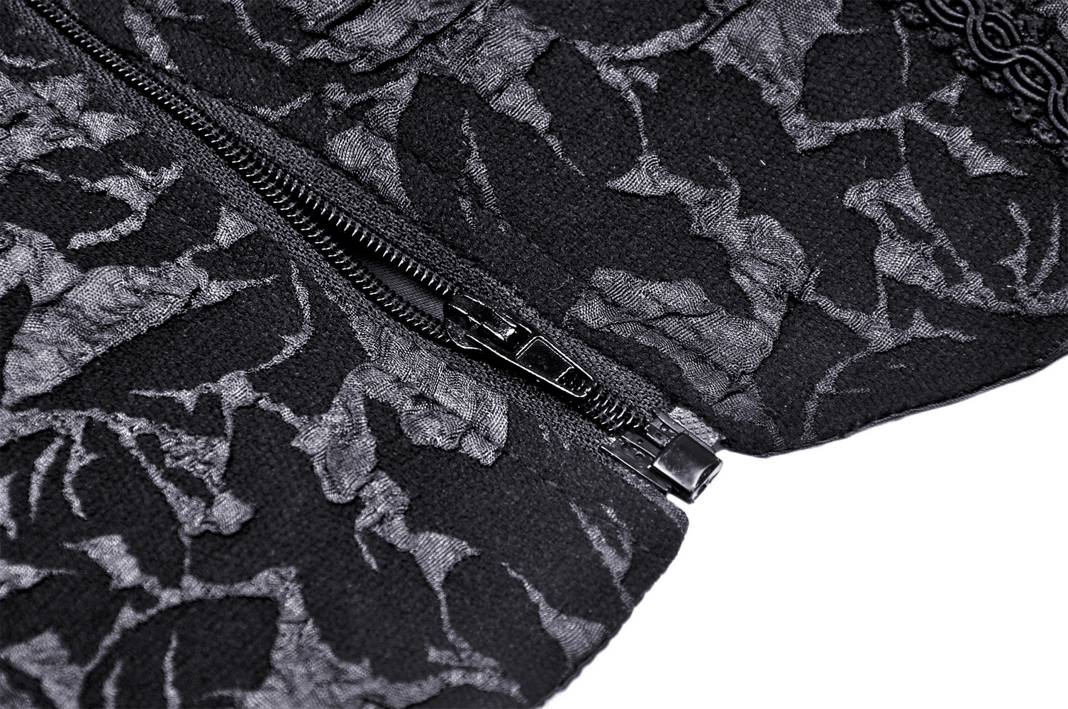 Close-up of a black lace-up corset with intricate lace detailing and a stylish zipper.
