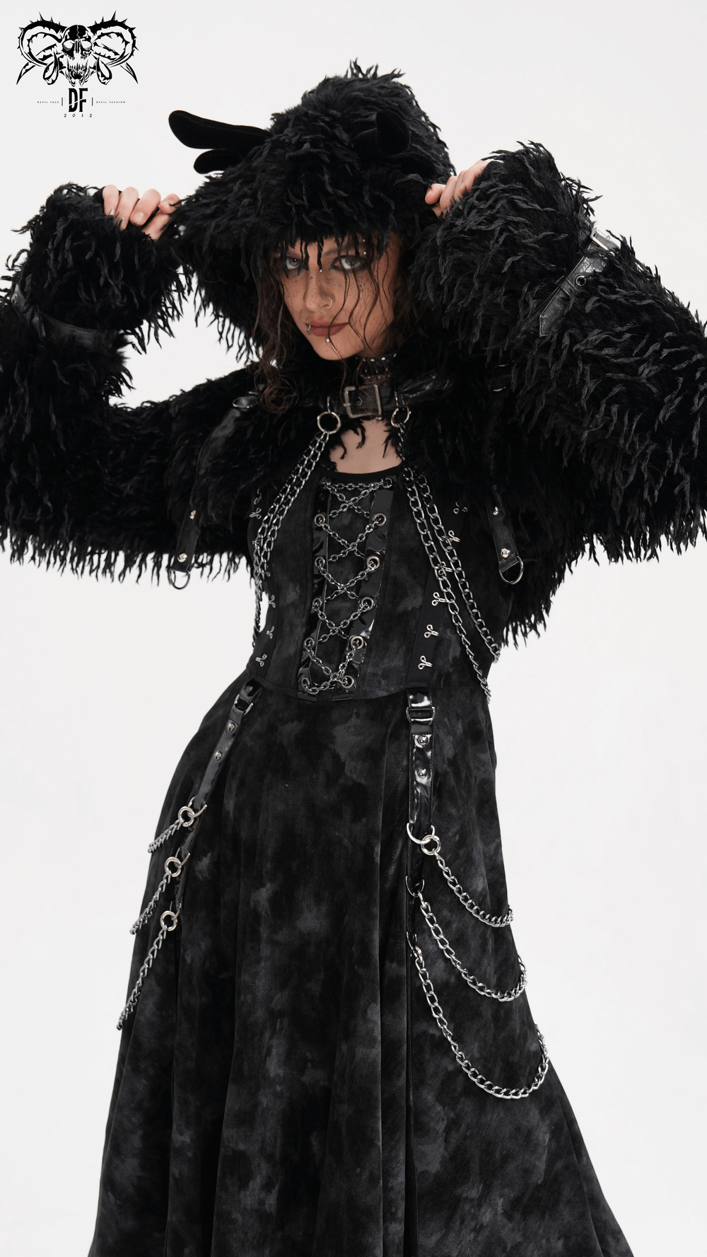 Model wearing a shaggy black faux fur cape with horns and chains, showcasing a bold gothic style.