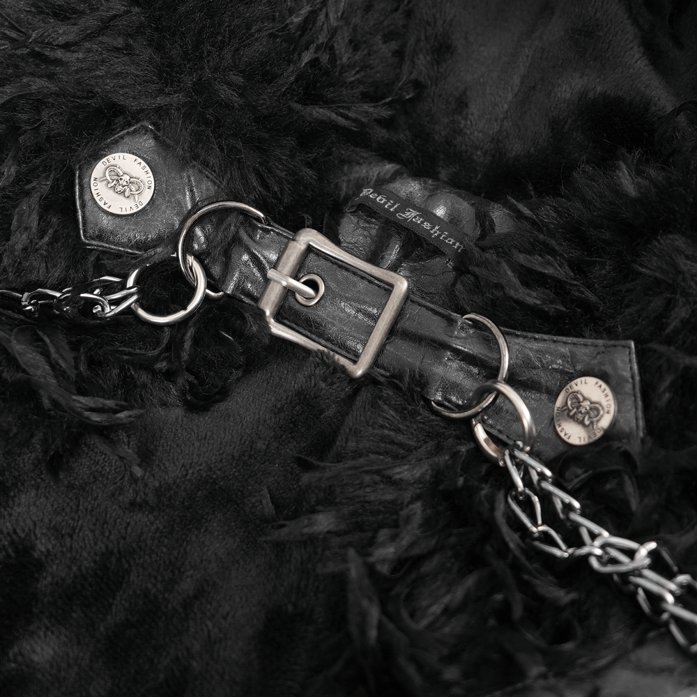 Close-up of gothic black faux fur cape clasp with silver chain and horn details, showcasing metal accents and texture.