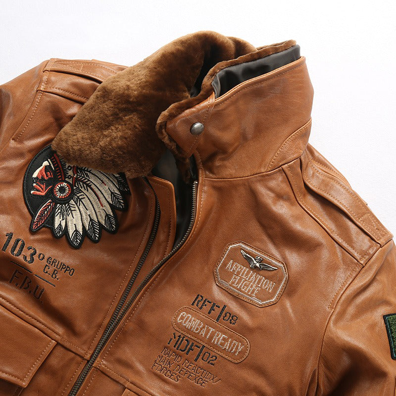 Vintage lambskin bomber jacket with fur collar and embroidered patches in camel color.