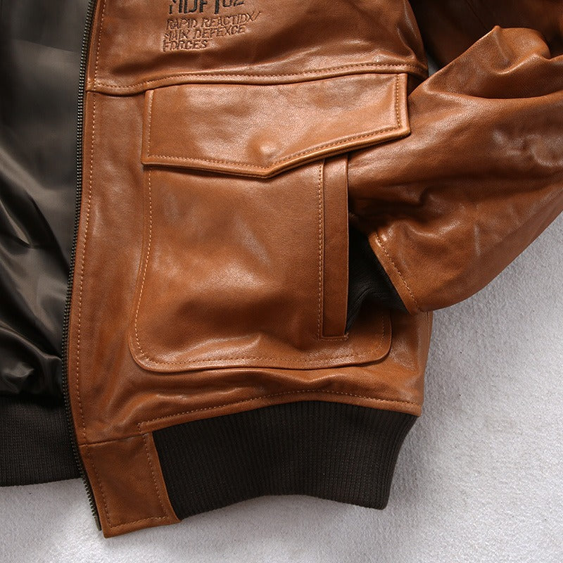 Brown vintage lambskin bomber jacket with fur collar, military style, featuring spacious pockets and ribbed cuffs.