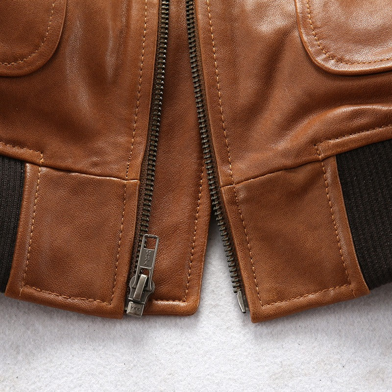 Close-up of the zipper and collar detail on a vintage lambskin men's bomber jacket in camel color.