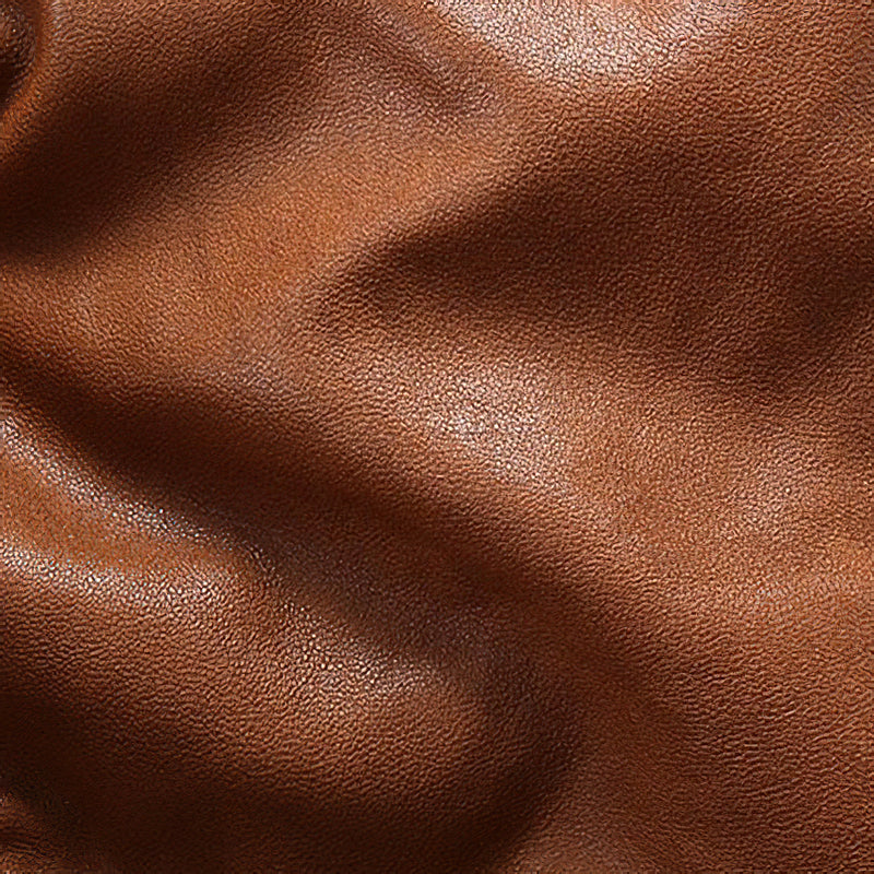 Close-up of soft, vintage brown lambskin leather texture, ideal for stylish bomber jackets.