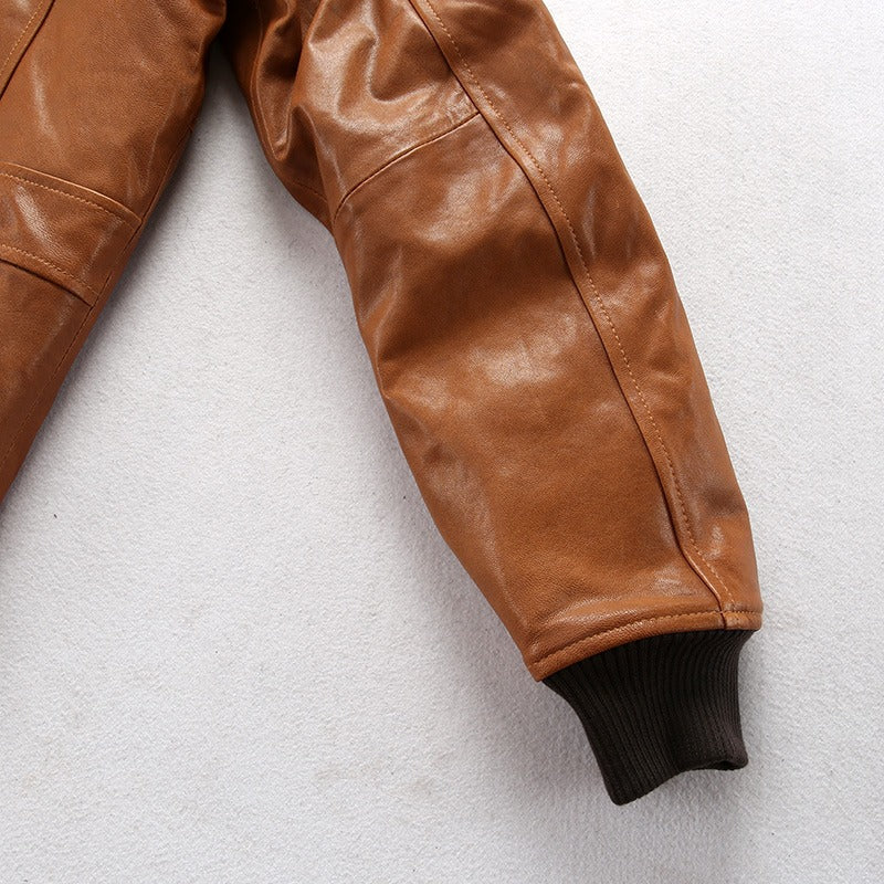 Close-up of the sleeve of a vintage lambskin bomber jacket in camel color with ribbed cuffs.