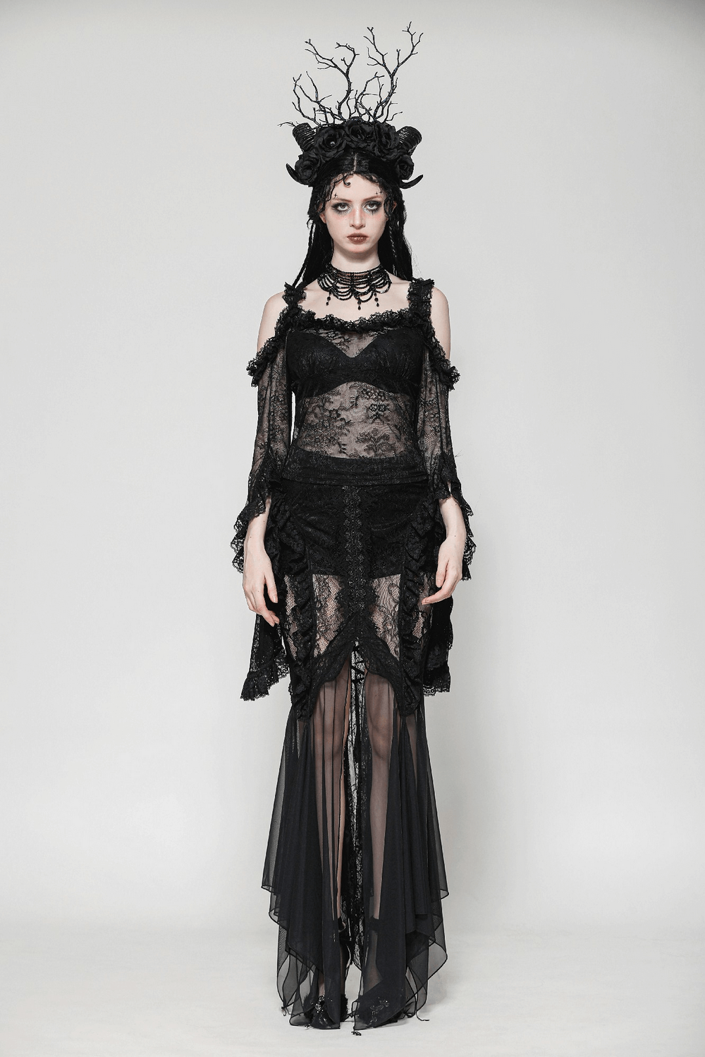 Gothic sheer black lace top with bell sleeves, paired with flowing skirt, capturing dark elegance and Victorian charm.