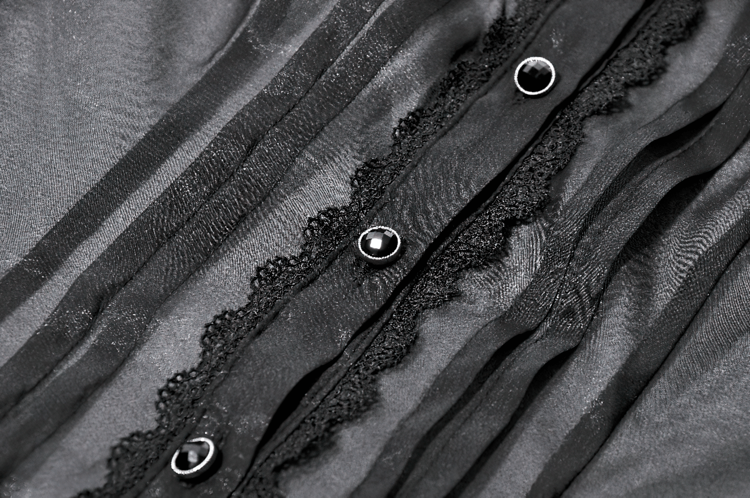 Sheer Gothic Blouse with Ruffled Hem and Lace Detailing close-up showing button and lace trim details.