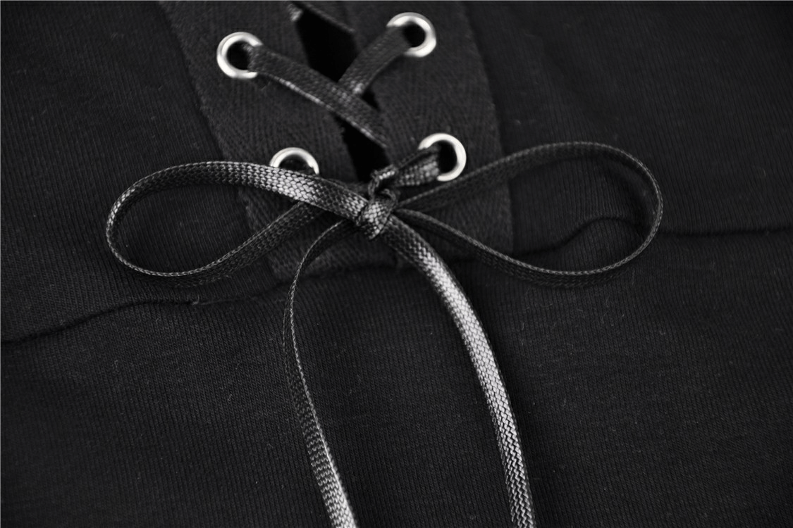 Close-up of lace-up detail on black sheer mesh top, showcasing edgy design and adjustable fit.