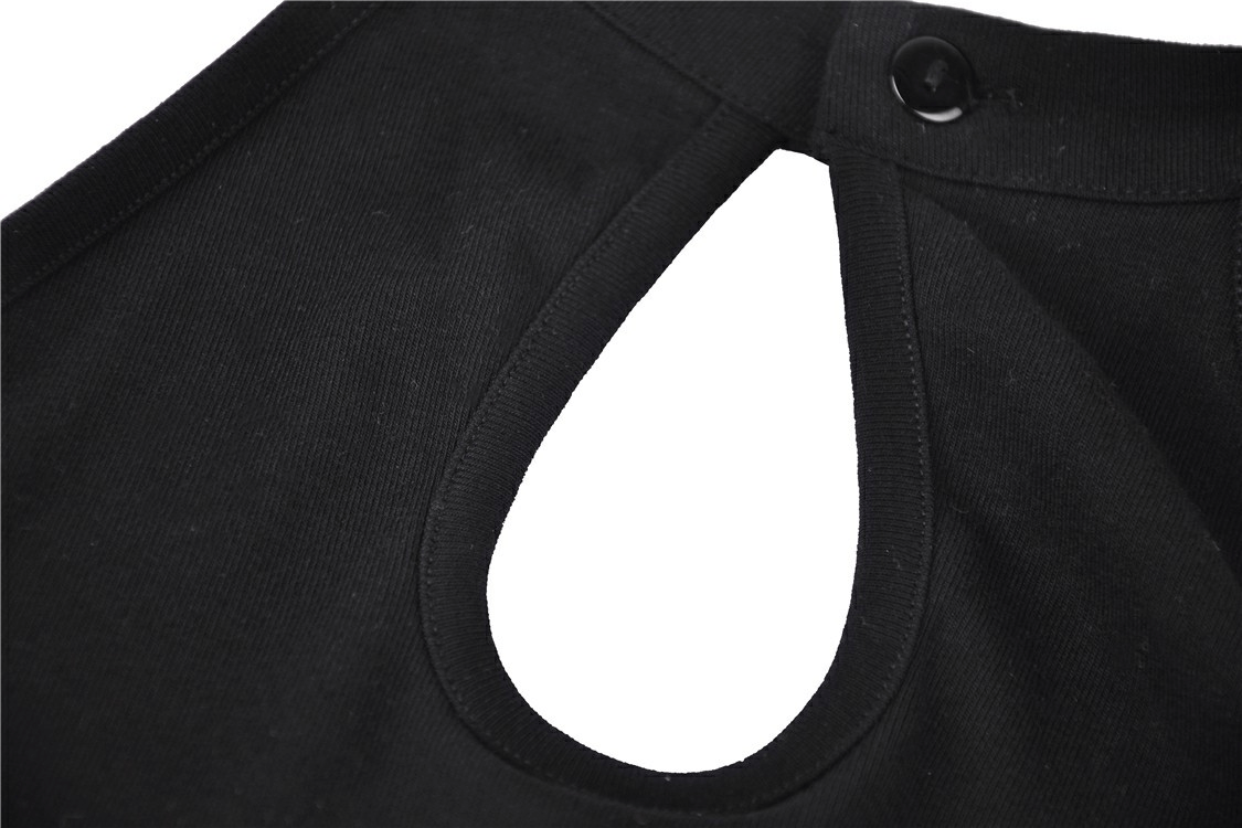 Close-up of the back keyhole detail on a black long-sleeved top with button closure for a stylish look.