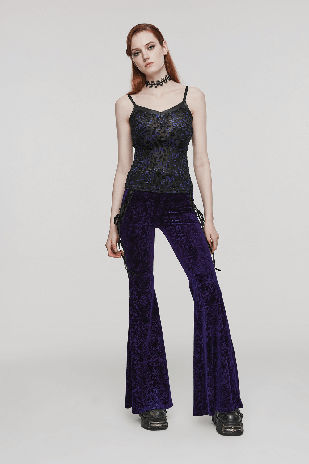 Goth women's outfit featuring a shimmer leopard mesh camisole and purple velvet flared pants, styled with chunky boots.