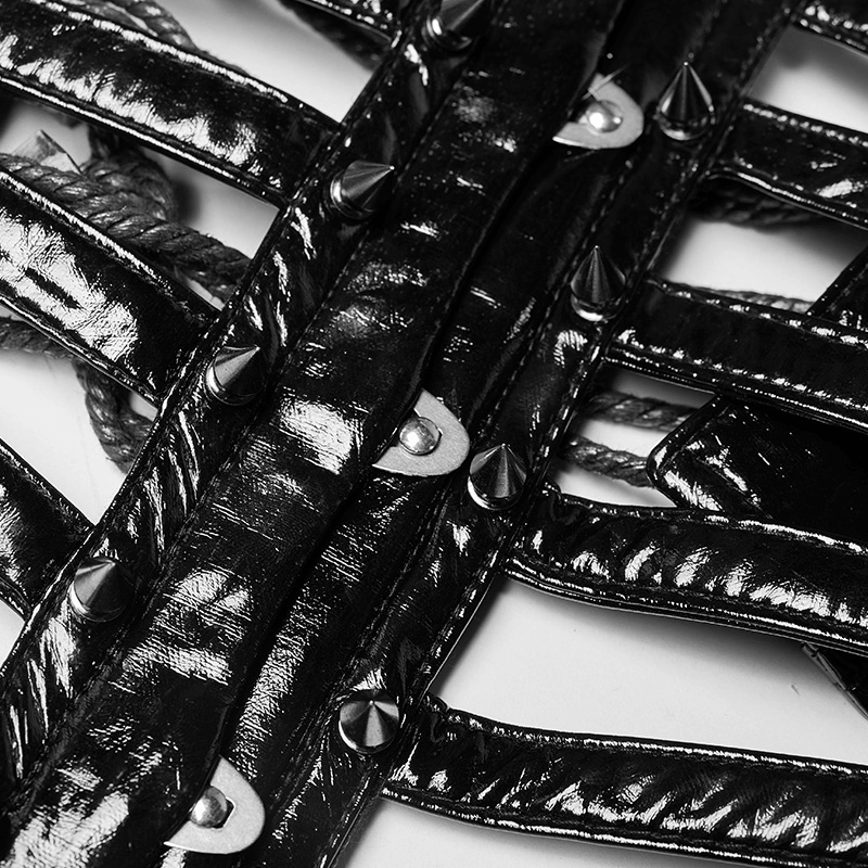Close-up of a shiny patent PU punk corset belt with metal cone studs and adjustable rope detailing.