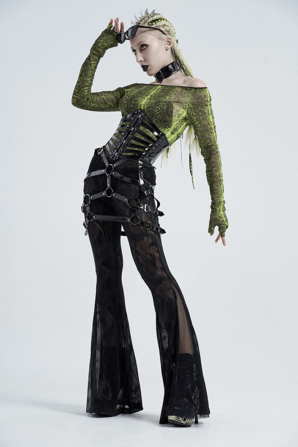 Model showcases edgy shiny patent PU punk corset belt with steel buckle and stylish layered outfit.