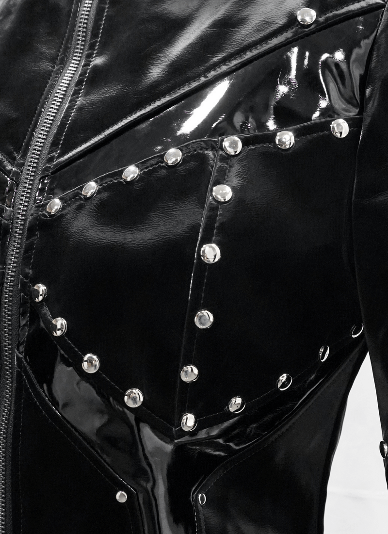 Close-up of a black shiny PU leather jacket with silver studs, showcasing a gothic style and edgy design.