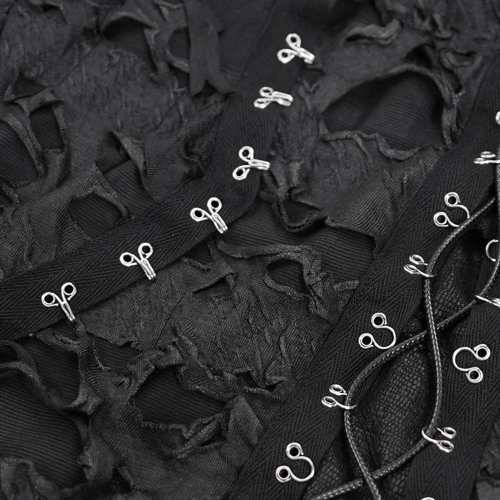 Close-up of shredded black fabric with lace-up design and silver accents on a gothic hoodie. Perfect for alternative fashion lovers.