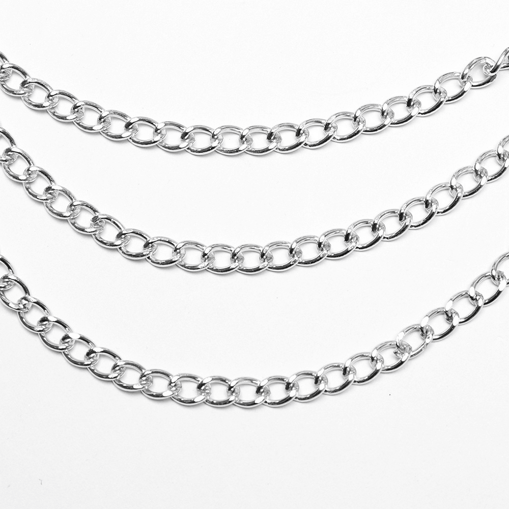 Close-up of layered silver chain links for a bold bra harness design, showcasing shiny metal accents and intricate details.