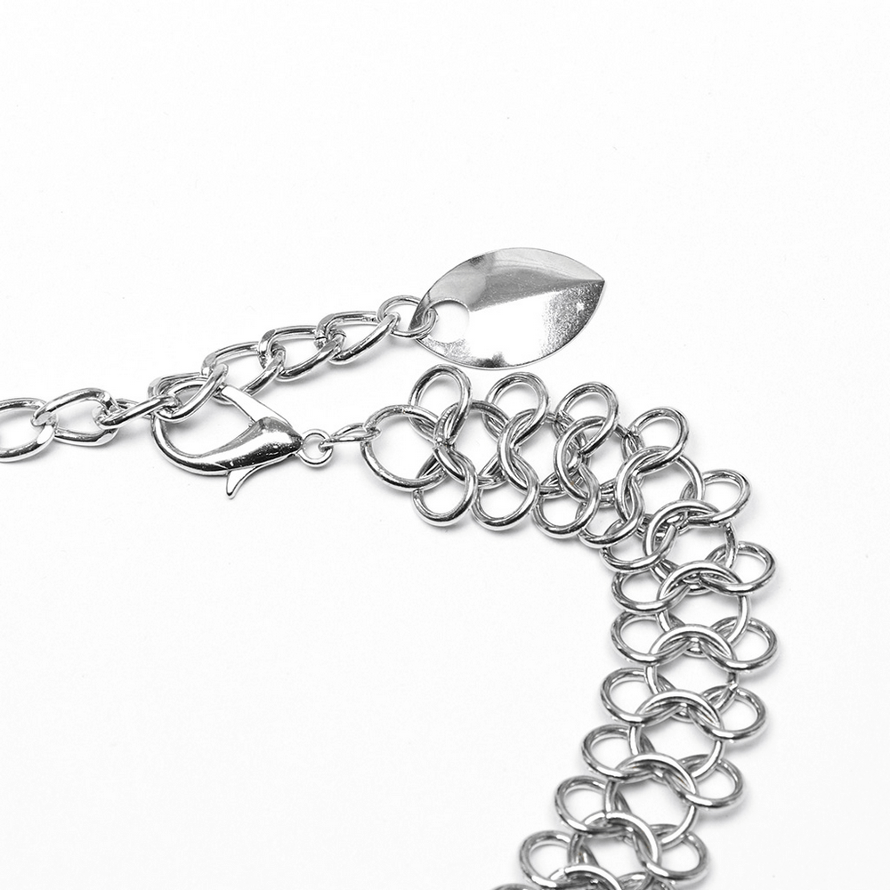 Close-up of a silver chain bra harness with layered metal scales and clasp detail, perfect for edgy fashion.