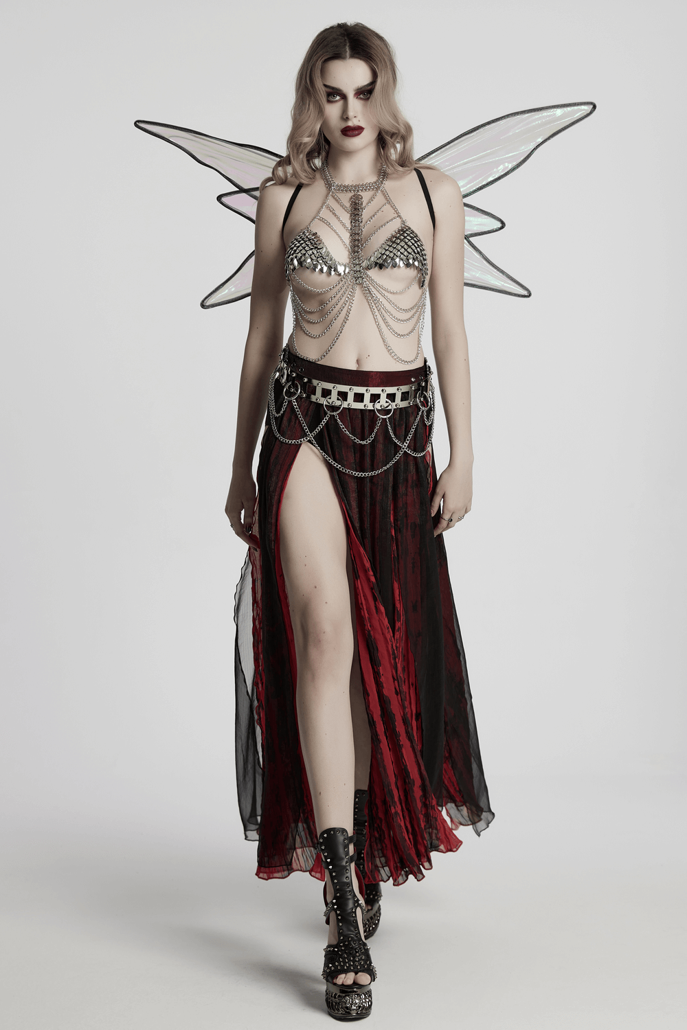 Model showcasing a silver dragon scale chain bra harness with flowing skirt and wings, perfect for festivals and edgy looks.