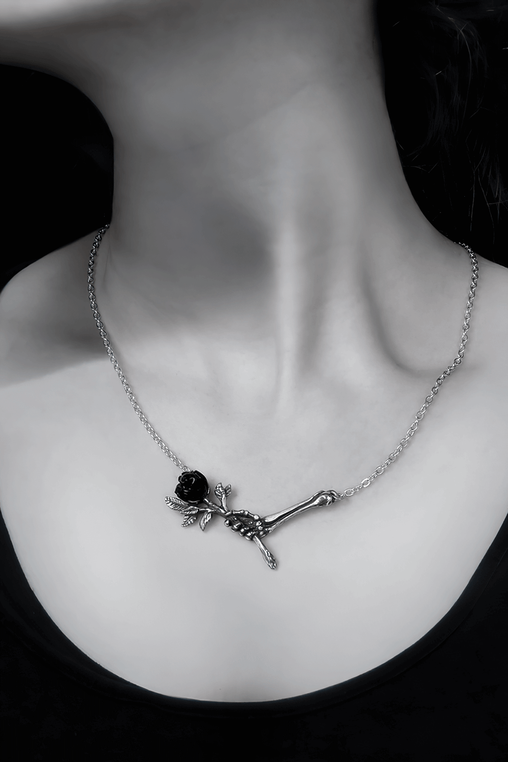 Gothic skeletal hand pendant necklace with black rose, perfect for dark elegance enthusiasts.