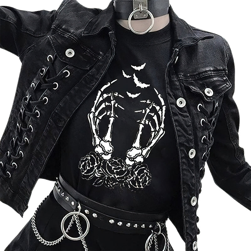 Women's black gothic t-shirt featuring skeleton fingers and roses, styled with a black denim jacket and punk accessories.