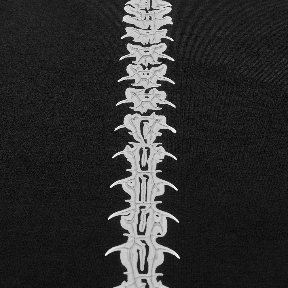 Close-up of ghost claw spine design on a black dress, showcasing bold and edgy fashion detail.