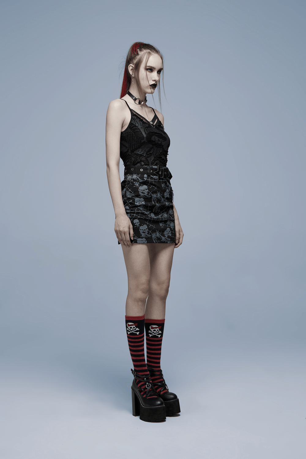 Model showcases a Skull Accent Gothic Lace Trim Camisole paired with bold accessories and striped socks.