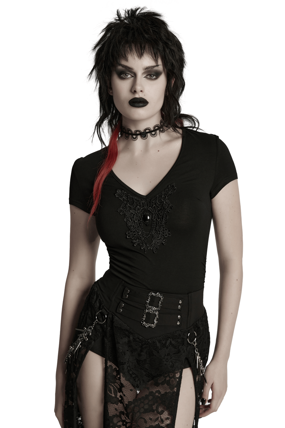 Stylish woman in a black V-neck t-shirt featuring a skull and lace motif, paired with edgy accessories.