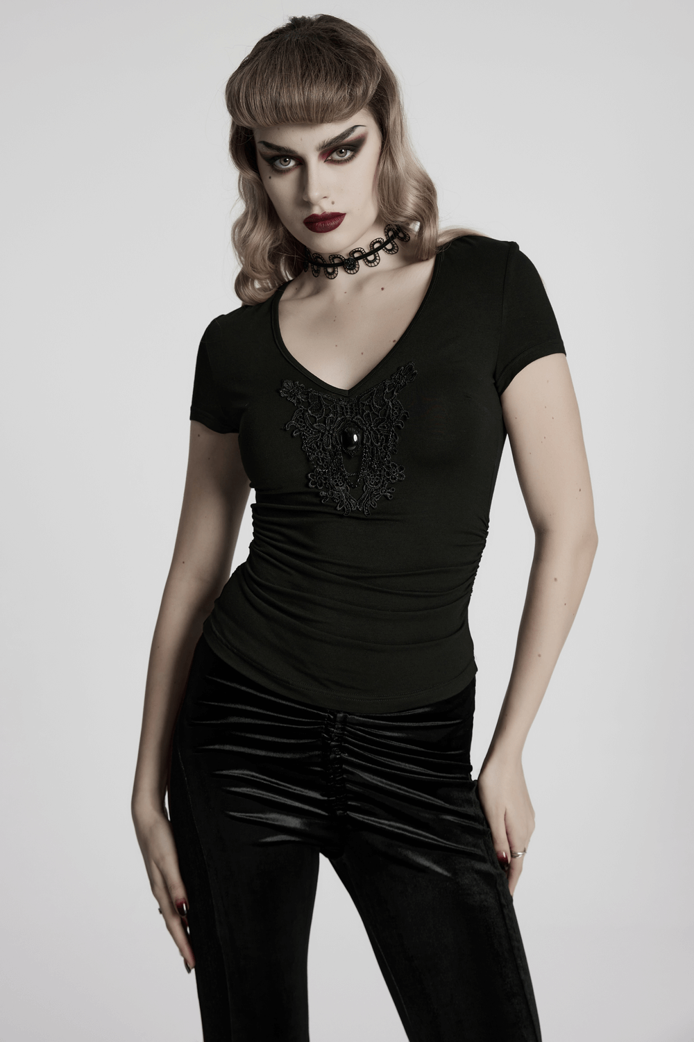 Women's Skull and Lace Black V-Neck T-Shirt showcasing a stylish design with a skull motif and fitted silhouette.