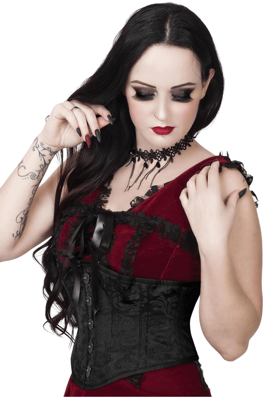 Wearing a black brocade underbust corset with intricate details, matching red velvet dress, bold makeup, and gothic accessories.