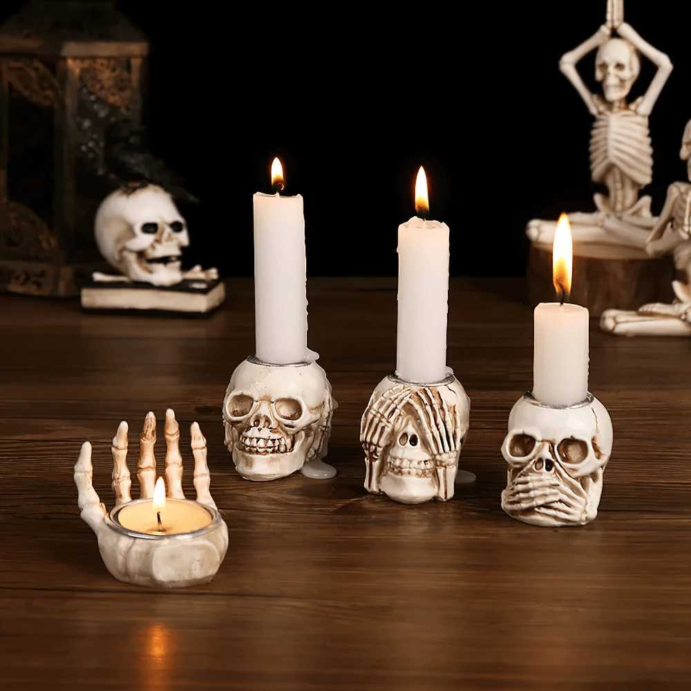 Gothic skull candle holders set with skeleton hands, perfect for Halloween and vintage decor.