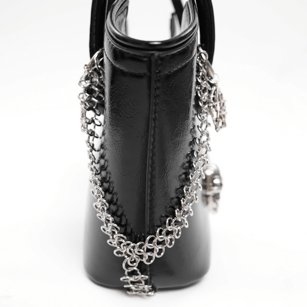 Back view of gothic tote bag showcasing chain link details and silver skull charm accents.