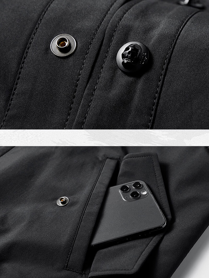 Close-up of skull button and phone pocket on black bomber jacket, blending style and functionality in military fashion.