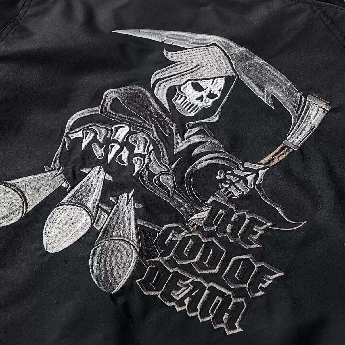 Skull and Grim Reaper embroidery on black bomber jacket, featuring the words 'The God of Death'.