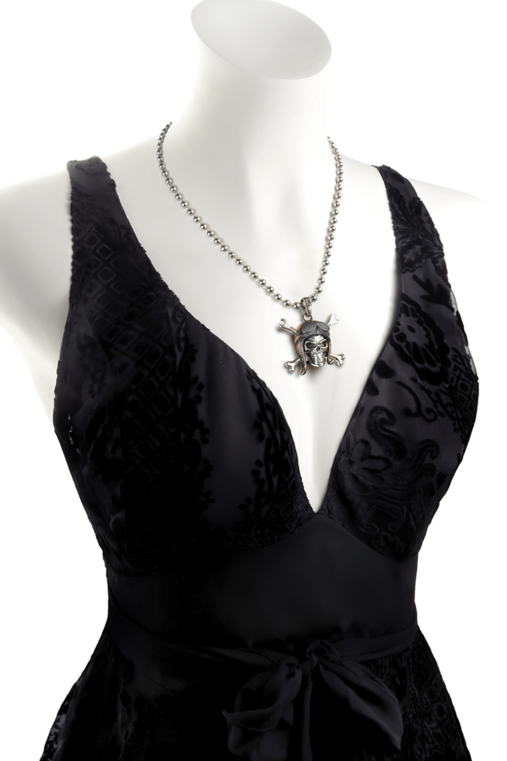 Skull Pilot Pendant with Crossed Spannerbones showcased on a black dress, exuding gothic flair and rebellious style.