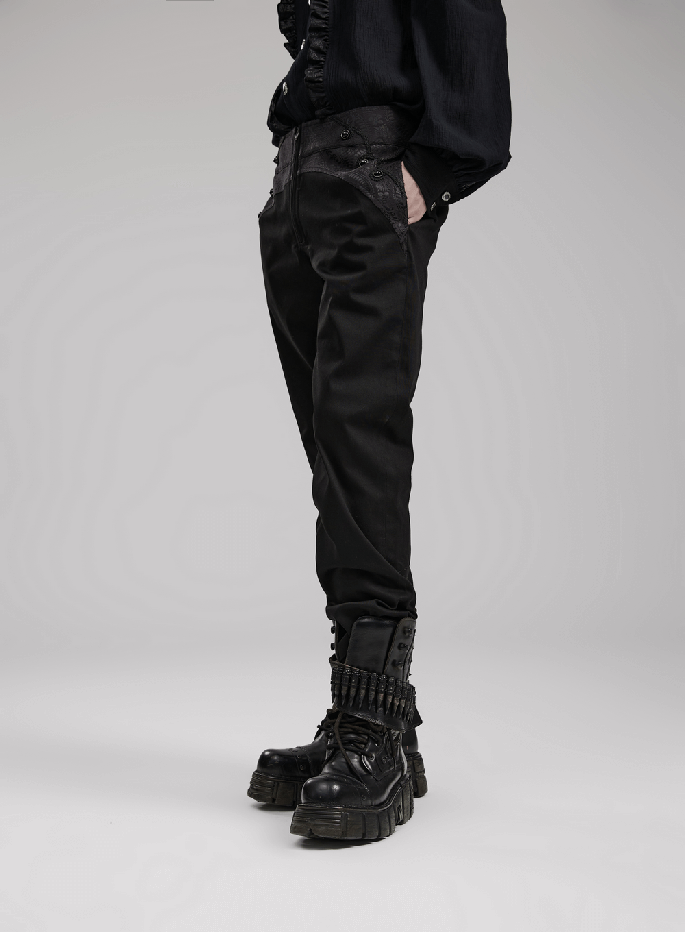 Sleek black gothic slim-fit trousers with pockets, styled with edgy boots and modern detailing.