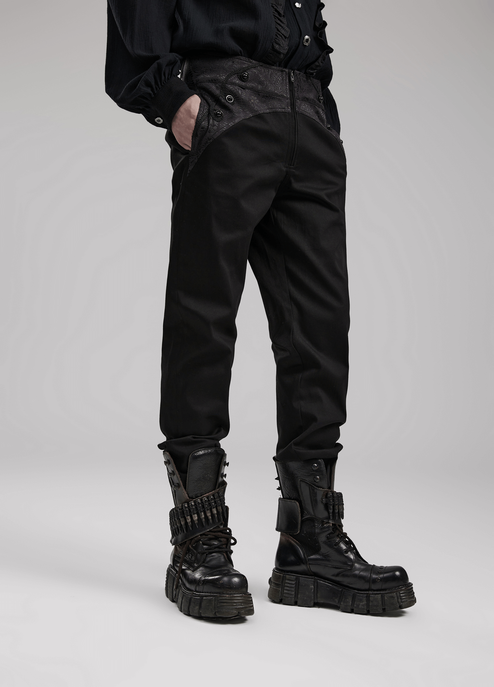 Stylish black gothic slim-fit trousers featuring webbing details, paired with edgy black combat boots.