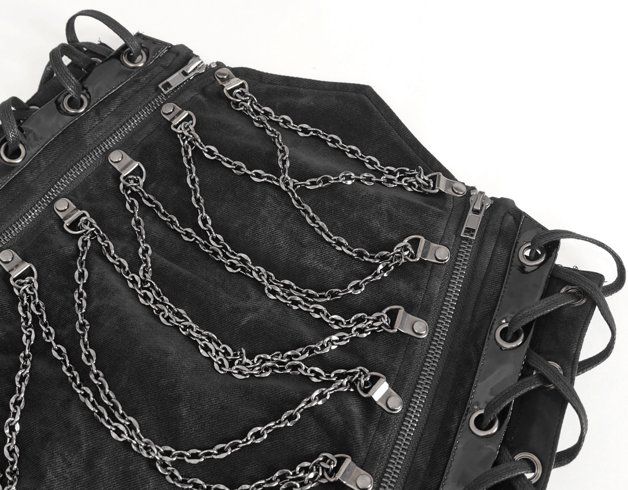 Close-up of a stylish black garment showcasing unique chain details and zippers for a chic look.