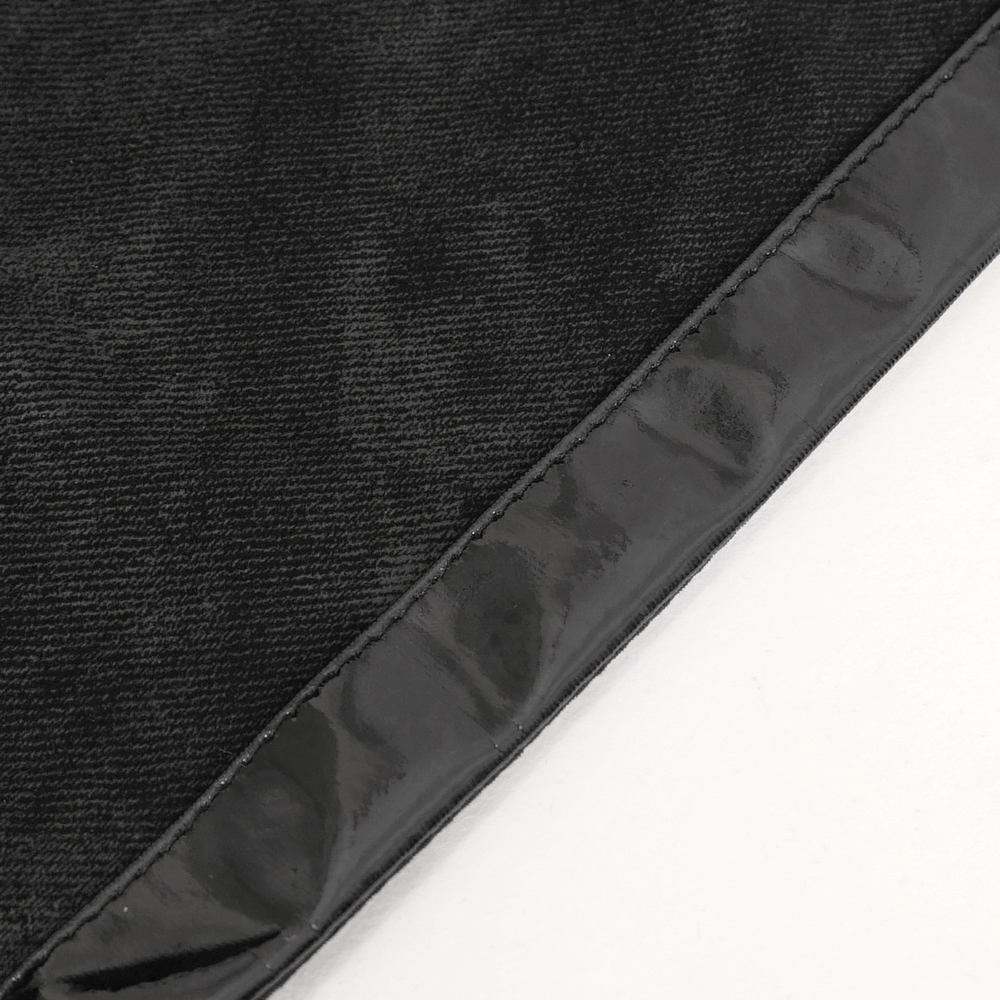 Close-up of the sleek black maxi skirt fabric showcasing glossy side lacing details for a stylish finish.