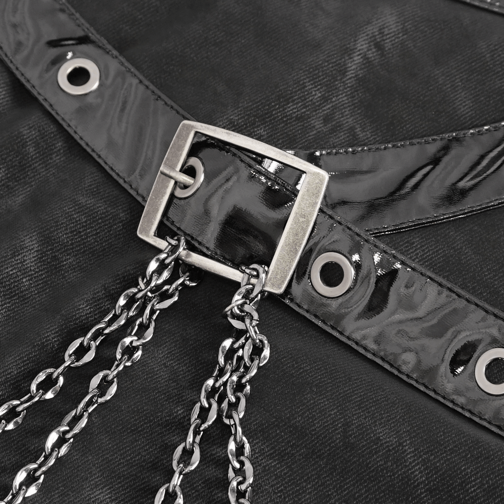 Close-up of stylish black maxi skirt with silver buckle and chain lace-up details.